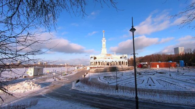 Timelapse is the historic building of the Northern River Station in Moscow after reconstruction against the background of fast-running clouds in a bright blue sky.