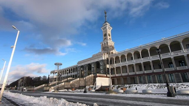 Timelapse is the historic building of the Northern River Station in Moscow after reconstruction against the background of fast-running clouds in a bright blue sky.