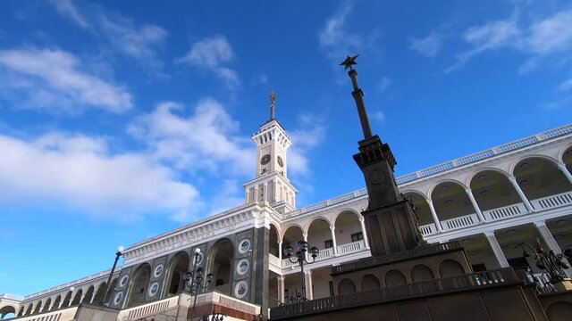 Timelapse is the historic building of the Northern River Station in Moscow after reconstruction against the background of fast-running clouds in a bright blue sky.
