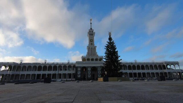 Timelapse is the historic building of the Northern River Station in Moscow after reconstruction against the background of fast-running clouds in a bright blue sky.