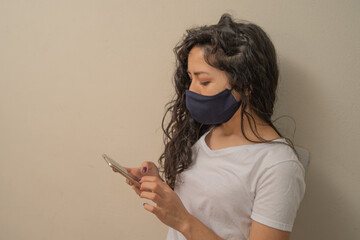 quarantined woman spending time looking at cell phone
