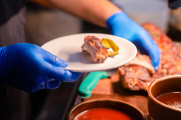 hotel staff chop bbq rips seperate on dish prepare for guest