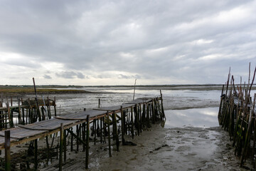 Fototapeta premium view of the broken old docks and piers at Cais Palatifico on the Sado River Estuary