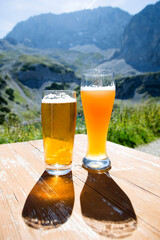 Two glasses of beer in mountain panorama