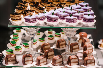 Table with muffins, cakes, sweets, candy, buffet. Dessert table for a party goodies for the wedding banquet area. Close up. candy bar. Decorated delicious.