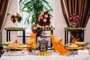 Fresh, exotic, organic fruits, light snacks in a plate on a buffet table. Assorted mini delicacies and snacks, restaurant food at event. Decorated delicious table for a party goodies.