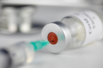 A bottle with vaccine and syringe, Coronavirus, Covid-19, Medicine, science and healthcare concept	
