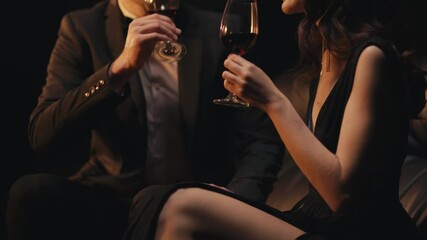 Cropped view of stylish couple with wine glasses toasting isolated on black