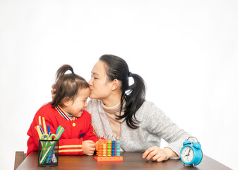 Young mother teaches her daughter to arithmetic