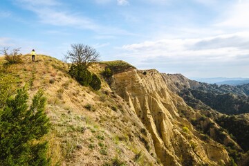 Female person walks around VAshlovani national park protected areas with beautiful landscape view of cliffs