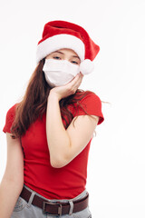 Fototapeta na wymiar girl wearing a medical mask santa hat red t-shirt christmas