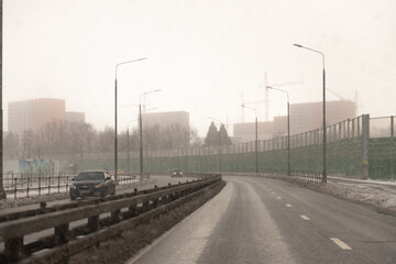 Snowfall on the road in the city.