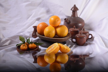 a bunch of fresh oranges on a white background, with free space to be creative.