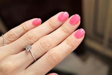 Hands pink nails with rings. Woman's nails. manicure