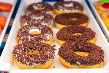 A tray of colorful donuts in a candy store in Asia