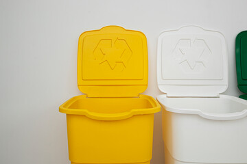 Three colorful trash cans for sorting garbage. For plastic, glass and paper