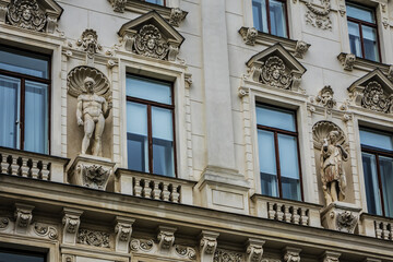 Fototapeta na wymiar Architectural details of old picturesque dwelling house at Reichsrats street (Reichsratsstrasse) in the historic center of Vienna. Vienna, Austria.