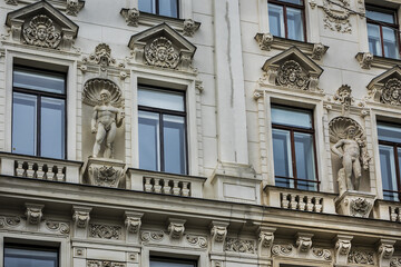 Fototapeta na wymiar Architectural details of old picturesque dwelling house at Reichsrats street (Reichsratsstrasse) in the historic center of Vienna. Vienna, Austria.