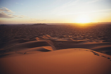 Fototapeta na wymiar Hiking and camel rifing in the highest dunes of Erg Chebbi, Sahara desert, Morocco