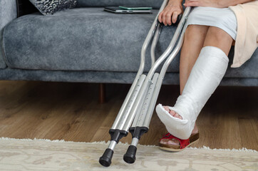 The middle aged woman with broken leg at home