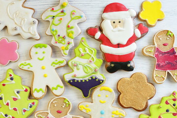 Homemade gingerbread 2021, sweet home pastry for Christmas and New Year, Christmas tree, gift sock, Saint Claus on white wooden background 