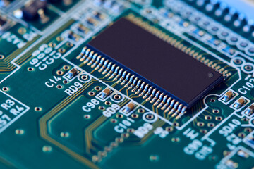 Electronic circuit board with electronic components such as chips close up. Blurry background.	