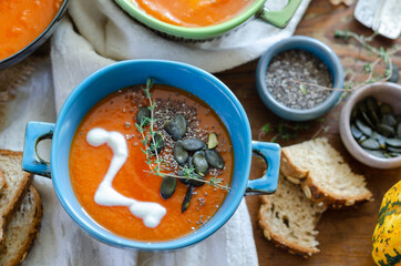 Pumpkin soup served  in bowl on the table