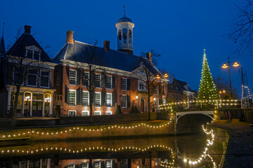 Fototapeta na wymiar Medieval city hall from Dokkum in the Netherlands at twiligt in christmas time