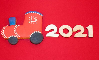 Christmas, New Year gingerbread locomative with numbers 2021. Happy New 2021 Year attributes concept on bright red background. Flat lay. 