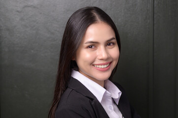 Business Woman is smiling in her office black background , confident woman , people lifestyle concept...