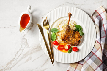 Roasted duck leg with puree and orange sauce