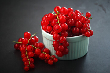 A ceramic bowl with red currant berries