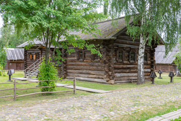 view of the old wooden houses in the park of Russian art in Kostroma, photo was taken on a cloudy summer day