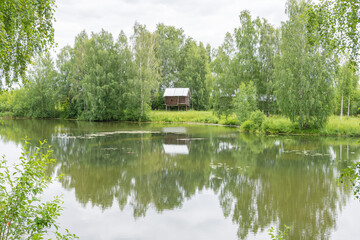 view of the old wooden houses in the park of Russian art in Kostroma, photo was taken on a cloudy summer day