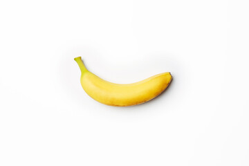 Single fresh raw clean isolated one alone horizontally oriented yellow banana on the bright solid white fond background