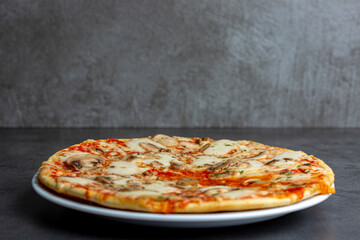 Simple mushroom pizza with crunchy crest and golden yellow orange tint studio low key still life in a contemporary kitchen counter
