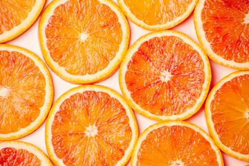 Fresh clean cuted slices of orange fruit rings stack pattern background
