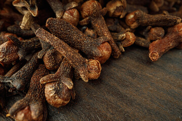 Heap of clove spice on wooden table
