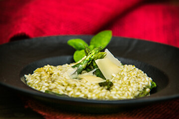 Risotto with asparagus and parmesan. The food in the restaurant. Food styling and restaurant meal serving.
