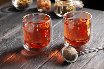 glass cups of fruit tea on wooden background
