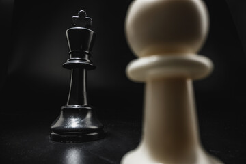 Chess game with chess pieces against black background
