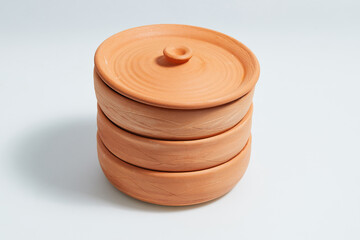 Earthenware with a lid for sprouting grain on a white background