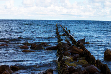 Breakwater in the Baltic sea. Barrier for waves made of wood