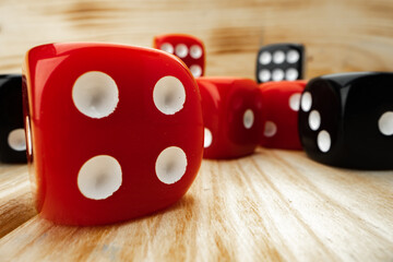 Red and black dice cubes on wooden background