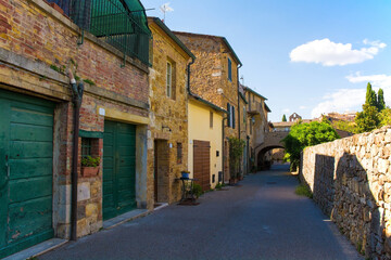 Fototapeta na wymiar A residential road in the historic medieval village of San Quirico D'Orcia, Siena Province, Tuscany, Italy 