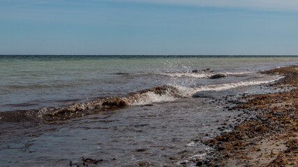 Fototapeta premium Waves and stones at a lovely beach in Denmark