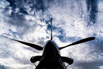 Naklejka na ściany i meble A Turboprop airplane propeller close-up with blue cloudy sky in the background