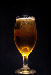 Beer, glass of cold beer with dark background, selective focus.
