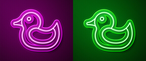 Fototapeta premium Glowing neon line Rubber duck icon isolated on purple and green background. Vector.