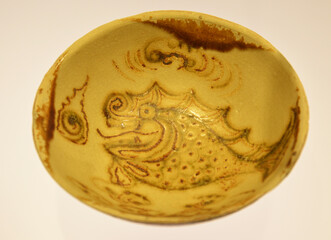 an old bowl with fish figure in the bottom showed in the museum in Shanghai